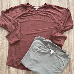 Pair of Athleta long sleeve relaxed fit athletic tops